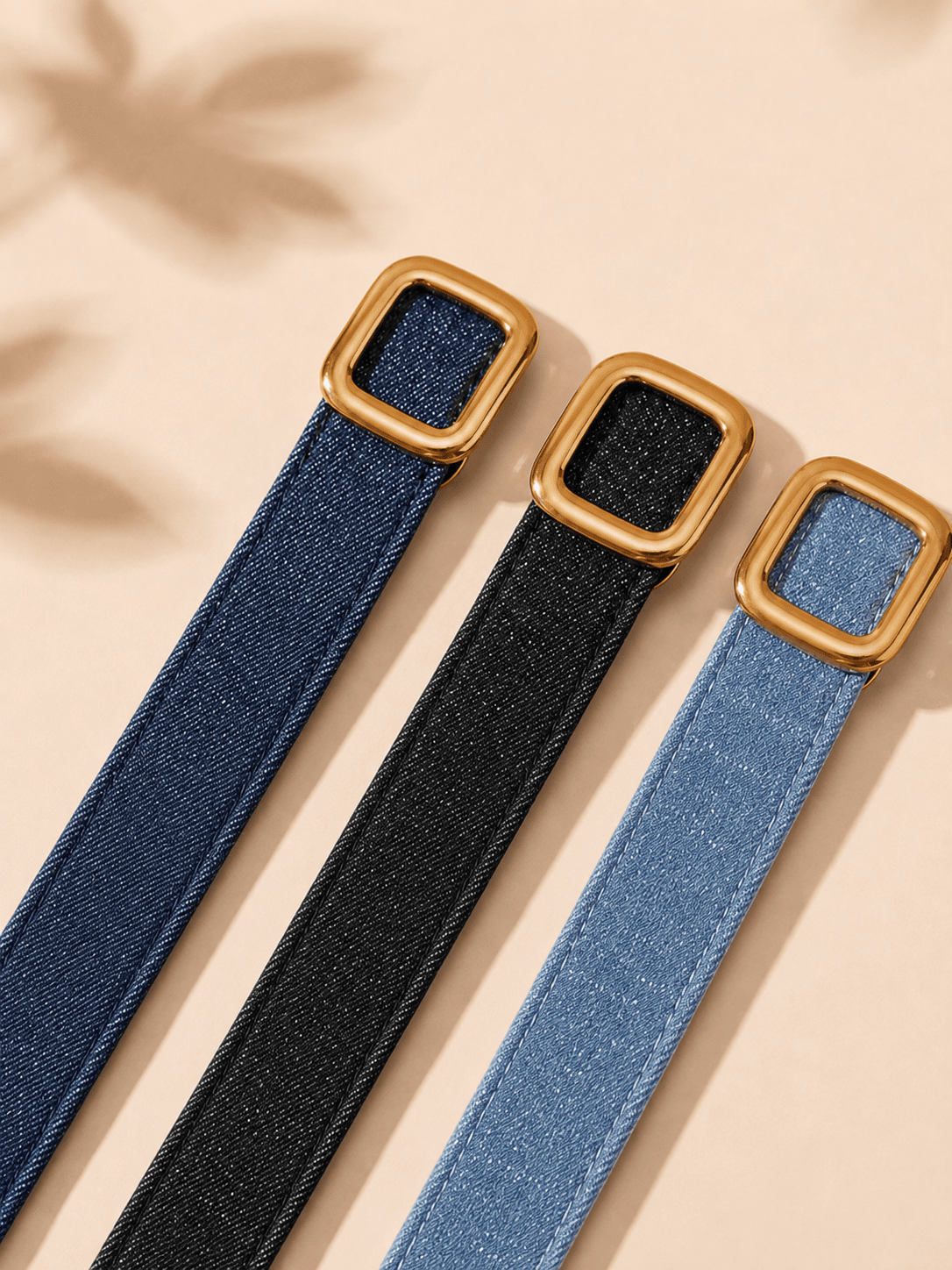Blue, black and light-blue denim belt colour directions with gold buckles