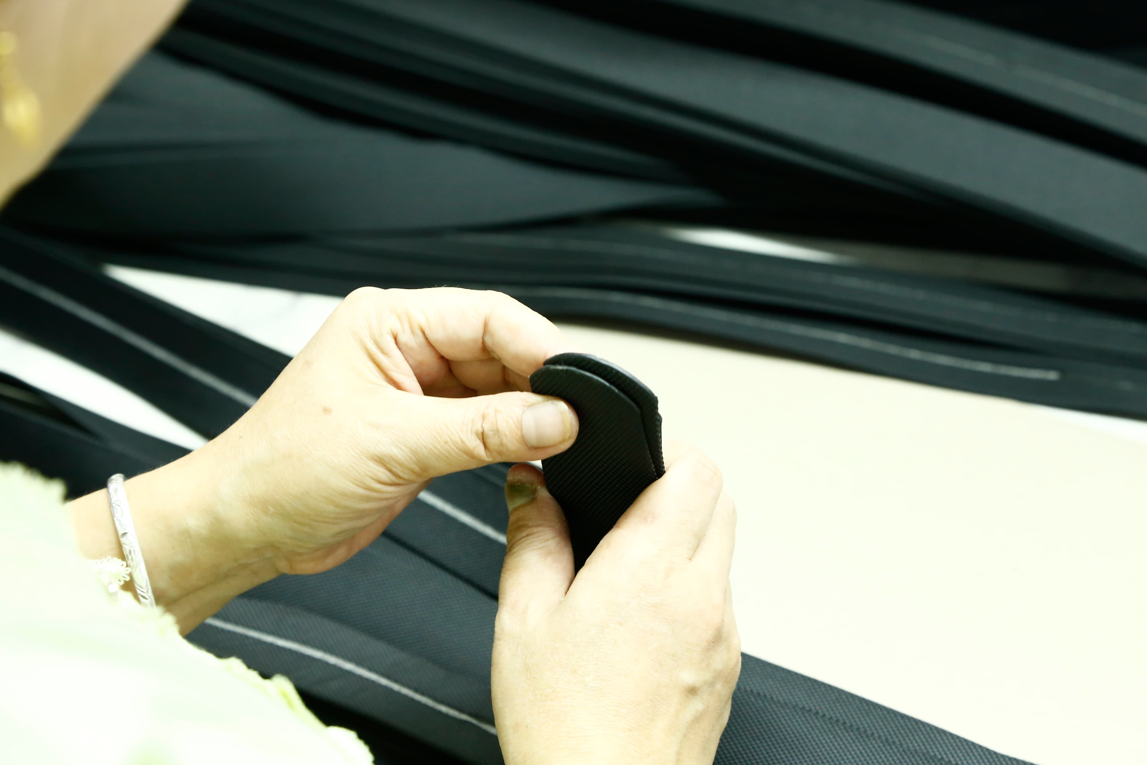 FKY team reviewing belt webbing during quality control